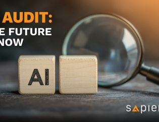 Two wooden blocks spelling "AI" (Artificial Intelligence) are positioned next to a large magnifying glass on a dark, textured surface, symbolizing the audit and scrutiny of AI systems. The text overlay reads "AI AUDIT: THE FUTURE IS NOW" in bold orange letters, and the Sapience logo is in the bottom right corner.